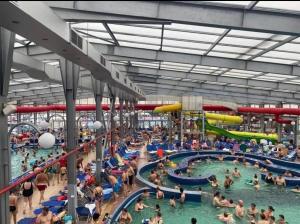 a large crowd of people in a swimming pool at Sun Garden Glamping Domes in Călimăneşti