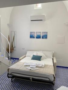 a bedroom with a bed with a blue and white floor at Villa Nina La torretta in Pontone