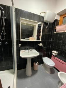 a bathroom with a sink and a toilet and a shower at Apartment Scalea La Petrosa TikiTakiApartments in Scalea +30 photos