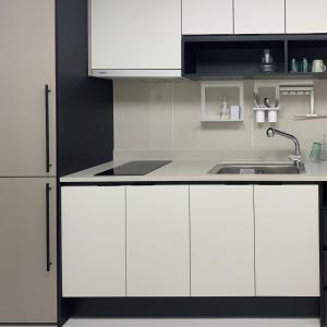 a white kitchen with a sink and a refrigerator at Daegu DSR Business Hotel in Daegu