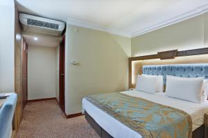 Postel nebo postele na pokoji v ubytování Budo Hotel
