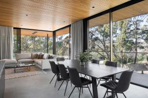 an open living room with a table and chairs at Highstead House in Daylesford