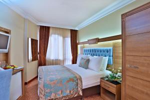Postel nebo postele na pokoji v ubytování Budo Hotel