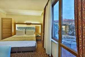 Postel nebo postele na pokoji v ubytování Budo Hotel