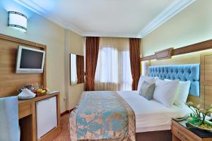 Postel nebo postele na pokoji v ubytování Budo Hotel
