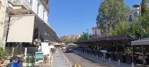 a street with a car parked next to a building at Thissio Hideaway Suite in Athens