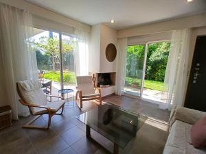 a living room with a couch and a coffee table at Garden house by the sea in Vari