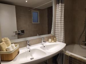 a bathroom with a sink and a mirror and a tub at Garden house by the sea in Vari +33 photos