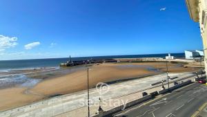 a view of a beach and the ocean at The Panoramic - Beach Front Apt - No Guest Fees in Kent