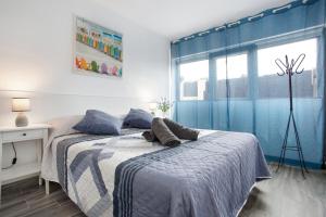a bedroom with a bed with a teddy bear on it at Casa Judit in Los Silos