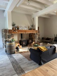 a living room with couches and a stone fireplace at Massu kiviait in Massu