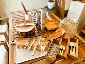 a wooden tray with wooden utensils on a table at TAITO BEACH HOUSE in Ichigaya