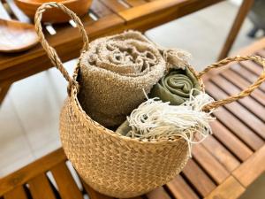 a rattan bag with yarns in it on a bench at TAITO BEACH HOUSE in Ichigaya