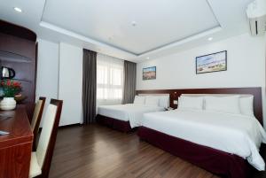Letto o letti in una camera di Dao Ngoc Hotel Da Nang