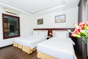 Letto o letti in una camera di Dao Ngoc Hotel Da Nang