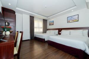 Letto o letti in una camera di Dao Ngoc Hotel Da Nang