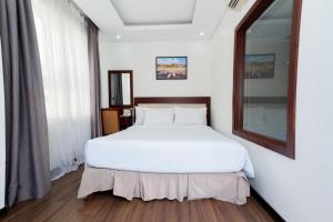 Letto o letti in una camera di Dao Ngoc Hotel Da Nang