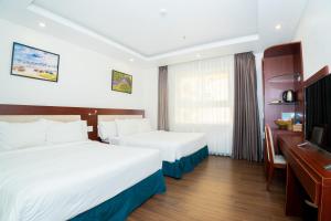 Letto o letti in una camera di Dao Ngoc Hotel Da Nang