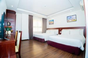 Letto o letti in una camera di Dao Ngoc Hotel Da Nang
