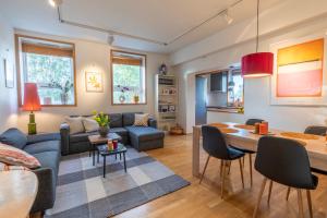 a living room with a couch and a table at Tromsø Town and Nature in Trondalen