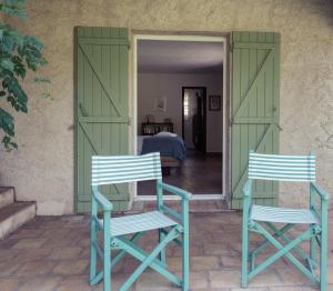 two chairs sitting on a patio with a bedroom at Villa Fontane Cottage in La Garde-Freinet +24 photos