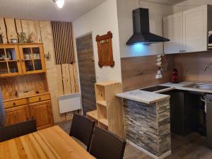 a kitchen with a table and a counter top at Le jas de l Ours - Chabanon in Selonnet