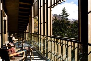 a balcony with chairs and a view of a mountain at The Chedi Andermatt in Andermatt