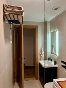 a bathroom with a sink and a glass door at Lavender Apartment - Close to the Beach - Private Garage Parking in Dobra Voda