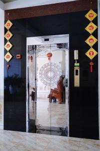 a room with a glass door with a sculpture on the wall at Kim Ngân Hotel Buôn Ma Thuột in Buon Ma Thuot