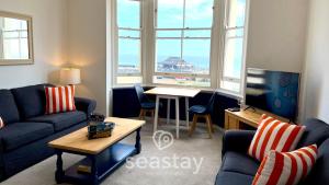 a living room with a couch and a table at Beach Lookout - Direct Beach Access - No Guest Fee in Kent