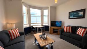 a living room with two couches and a tv at Beach Lookout - Direct Beach Access - No Guest Fee in Kent