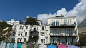a large white building with a lot of colorful houses at Beach Lookout - Direct Beach Access - No Guest Fee in Kent