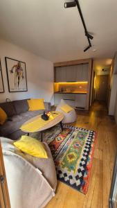 a living room with a couch and a table at Private Apartment Dado - Aparthotel Vučko in Jahorina