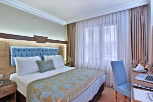 Postel nebo postele na pokoji v ubytování Budo Hotel