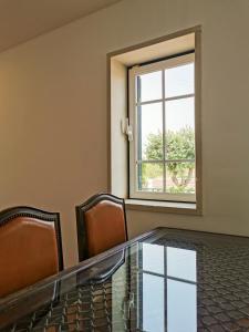 a conference room with a glass table and chairs at Casa do Limoeiro in Praia da Areia Branca +50 photos