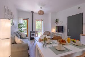 a living room with a table with food on it at Le Sureau Noir S34 - Le Val Joly in Eppe-Sauvage