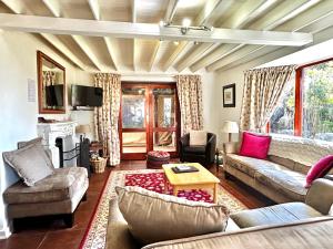 a living room with a couch and a table at Galashiels in Dullstroom