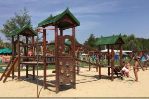 a playground on the beach with people playing at Dézsa Apartman Balatonalmádi in Balatonalmádi