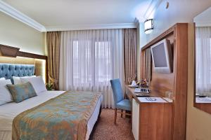 Postel nebo postele na pokoji v ubytování Budo Hotel