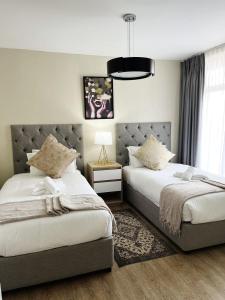 En eller flere senge i et værelse på Exclusive Stays @ Rea's Oceanic Hotels