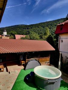 a hot tub sitting on top of a green lawn at Alpine Bliss Sinaia in Sinaia