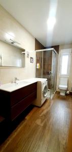 a bathroom with a sink and a washing machine at Despertar en León, al lado de la Catedral in León +6 photos