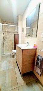 a bathroom with a sink and a toilet and a mirror at Despertar en León, al lado de la Catedral in León