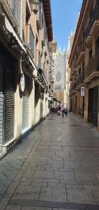 an empty street in a city with buildings at Despertar en León, al lado de la Catedral in León