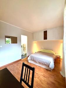 a bedroom with a bed and a chair in it at Maison Familiale 3 Chambres, 3 Salle de Bain, Proche RER A - Paris - Disney in Saint-Maur-des-Fossés +41 photos