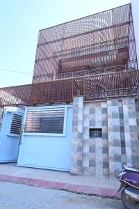 a building with a garage with a fence on it at HOTEL AYODHYA PAYING GUEST in Ayodhya