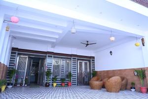 a building with a white ceiling with potted plants at HOTEL AYODHYA PAYING GUEST in Ayodhya