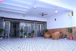a lobby of a building with chairs and plants at HOTEL AYODHYA PAYING GUEST in Ayodhya