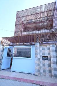 a building with a garage with a fence on top at HOTEL AYODHYA PAYING GUEST in Ayodhya