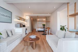 a living room with a white couch and a table at Seaside 8 l Aparthotel 50m from the Promenade in Cape Town